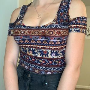 A brown shirt with tribal prints and elephants.